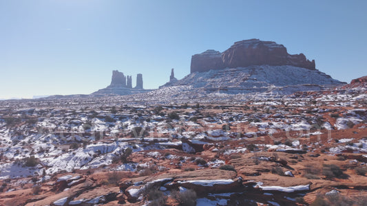 Snowfall Across Monument Valley – Winter Desert Aerial (4K